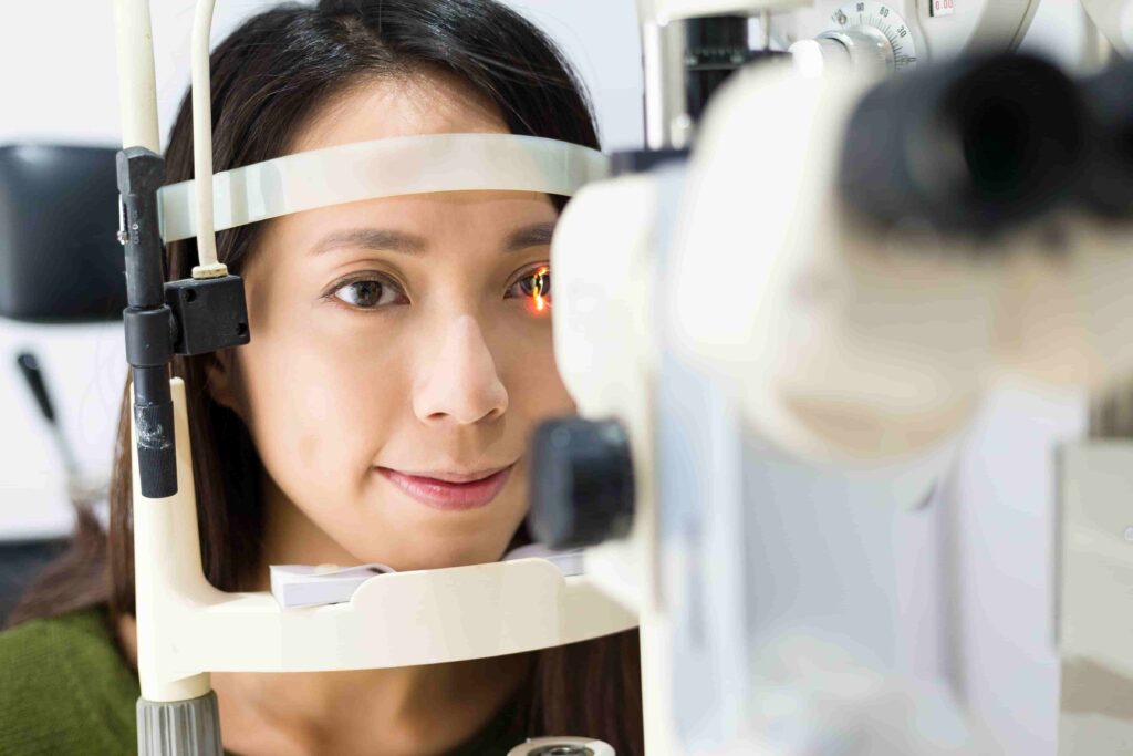 Patient receiving an eye exam with a slit lamp
